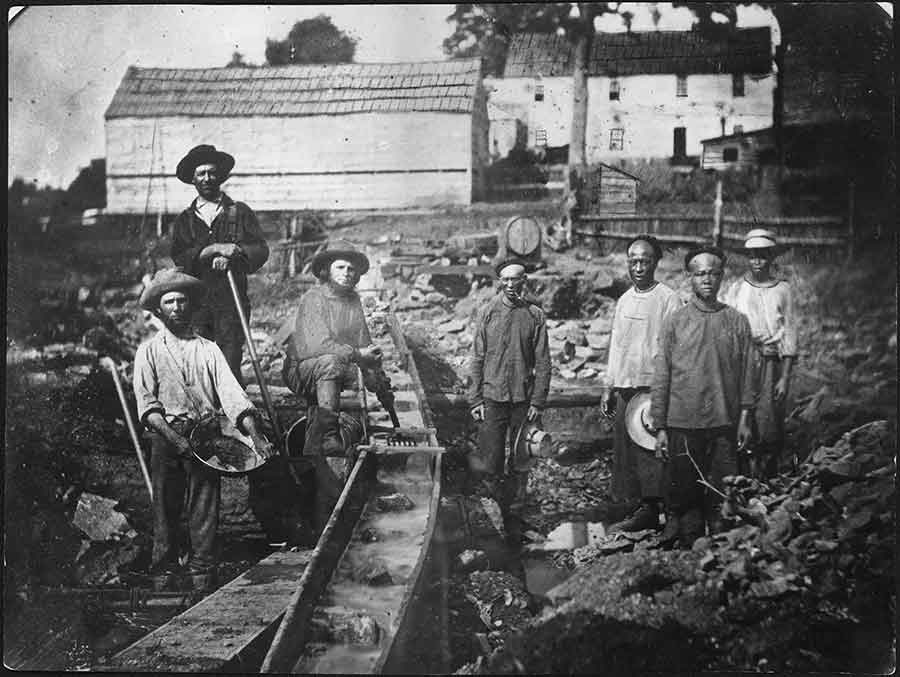 White and Chinese miners working beside a sluice box at Auburn Ravine in 1852